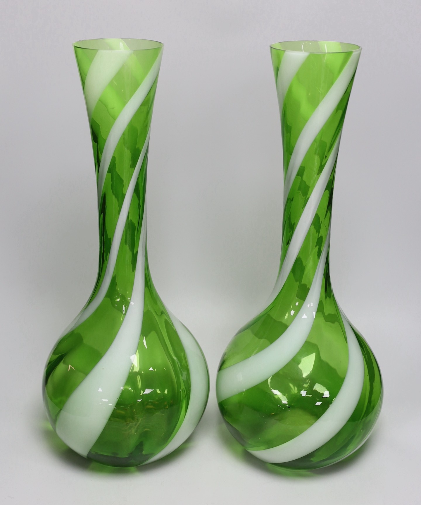A pair of tall Murano green and white swirled glass vases and another Murano glass vase, tallest 50cm